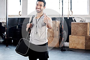 Portrait, thumbs up and happy man in gym with bag for sports goals, fitness target and training. Face, like hand gesture
