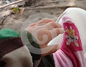 portrait of tiny baby hands and pink socks