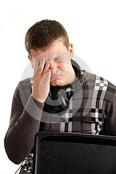 portrait of tired businessman using laptop