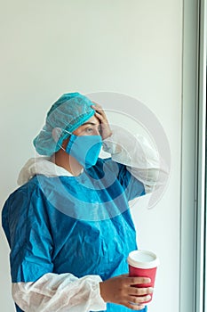 Portrait of a tired doctor wearing a surgical mask Exhausted feeling of depression of essential workers