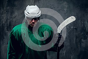 Portrait of tired hockey player in protective uniform.