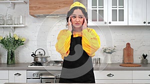 Portrait tired housewife in home kitchen massages neck after intensive cooking