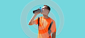 Portrait of tired runner man drinking from bottle the water or protein shake, male sportsman resting after hard training isolated