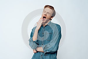 Portrait of Tired Sleepy Young Man Yawning