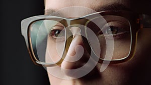 Portrait tired student girl closing eyes glasses in black studio.Businesswoman