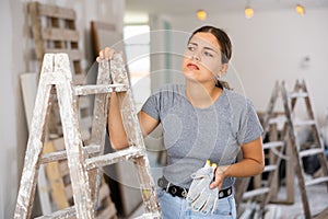 Portrait of tired woman in apartment during repair works