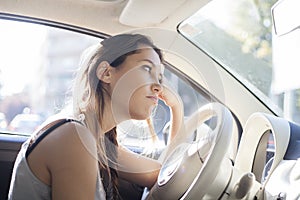 Portrait of tired woman driving car