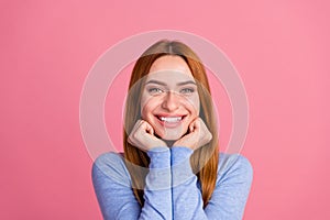 Portrait of toothy beaming girl with foxy hairdo wear blue pullover keep hands on cheeks smiling isolated on pink color