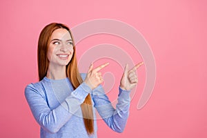 Portrait of toothy beaming girl with foxy hairdo wear blue pullover look directing at sale empty space isolated on pink