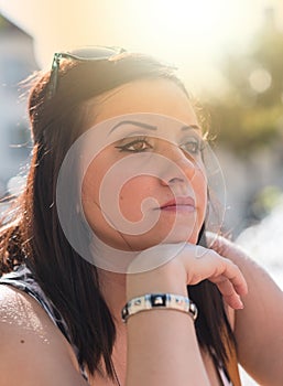 Portrait of toughtful young woman, light effect
