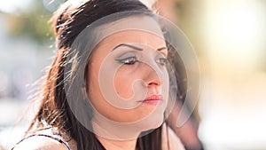 Portrait of toughtful young woman, light effect