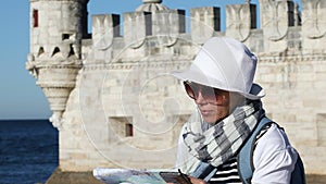 Portrait of tourist girl studying a map