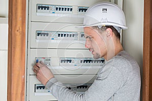 portrait tradesman repairing fuseboard