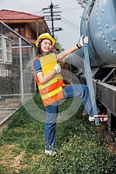 portrait train locomotive engineer women worker. Happy Asian young teen smiling work at train station train track locomotive