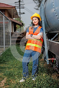 portrait train locomotive engineer women worker. Happy Asian young teen smiling work at train station train track locomotive