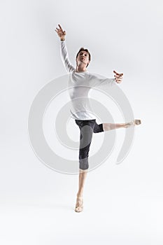 Portrait of Training Caucasian Young, Handsome Sporty Athletic Ballet Dancer with Lifted Hand Over White