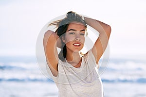 Portrait, travel and woman at beach for summer vacation, fun and solo holiday trip outdoor in nature. Ocean, face and