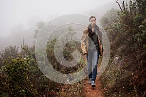 Portrait, travel and woman in nature for hiking, wellness or morning walk outdoor in winter. Path, trekking and female