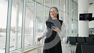 Portrait of a traveling business woman talking on cell phone at airport, happy student with suitcase run on flight happy
