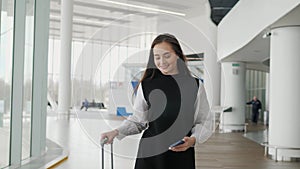 Portrait of a traveling business woman talking on cell phone at airport, happy student with suitcase run on flight happy