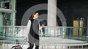 Portrait of a traveling business woman talking on cell phone at airport, happy student with suitcase run on flight happy
