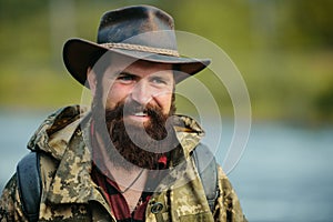 Portrait of traveller bearded man in cowboy hat. Close up portrait of happy middle aged smiling man in a countryside.