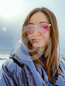 Portrait of trendy Korean woman on winter beach. Fashionable Asian girl on sea shore. Japanese female person outdoors