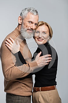 Portrait of trendy mature couple hugging