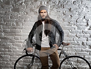 Portrait of trendy urban man with bicycle