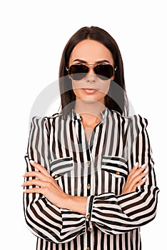 Portrait of trendy young woman in spectakles with crosed hands