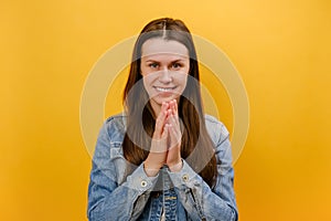 Portrait of tricky cunning smiling young caucasian woman standing looking at camera, planning something, pranking somebody,