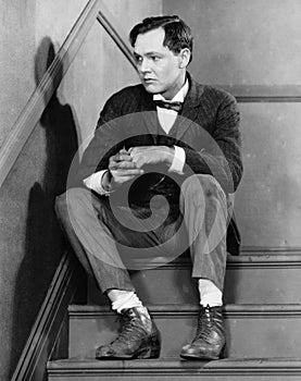 Portrait of troubled man sitting on stairs photo