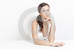 Portrait of troubled woman over white background