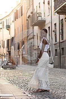 Portrait of turist woman dressed in white getting to know Europe, Ferrara. Italy