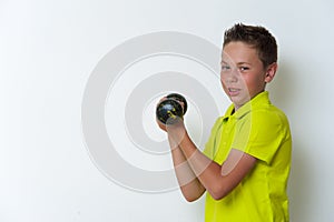 Portrait of tween fit boy with dumbbell