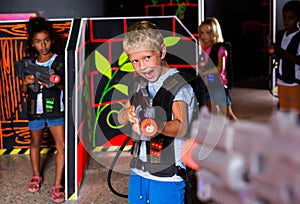 Portrait of tweenager boy with laser gun