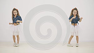 Portrait twin caucasian girls dancing at the camera in 4k slowmotion video.