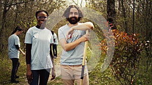 Portrait of two activists clearing up the forest surroundings