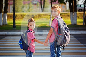 Portrait two adorable boys with backpack near pedestrian crossin