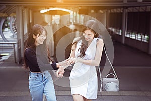 Portrait of two asian best friends smiling and feeling happy walking together