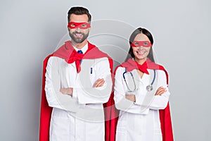 Portrait of two attractive cheerful docs super team career folded arms save life isolated over grey color pastel