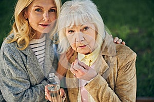 Portrait of two beautiful mature women posing to the camera