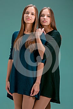 Portrait of two beautiful twin young women