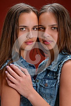 Portrait of two beautiful twin young women