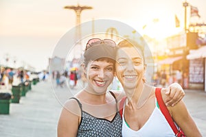 Portrait of two beautiful women in Coney Island at sunset