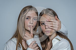 Portrait of two beautiful young girls, close up
