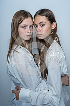 Portrait of two beautiful young girls, close up