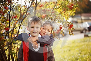 Portrait of two boys, brothers and best friends smiling. Friends hugging.