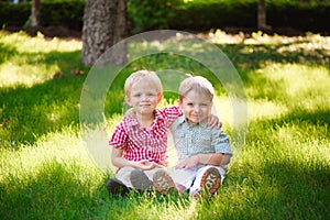 Portrait of two boys embracing and laughing outdoors