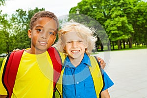 Portrait of two boys hugging on shoulders